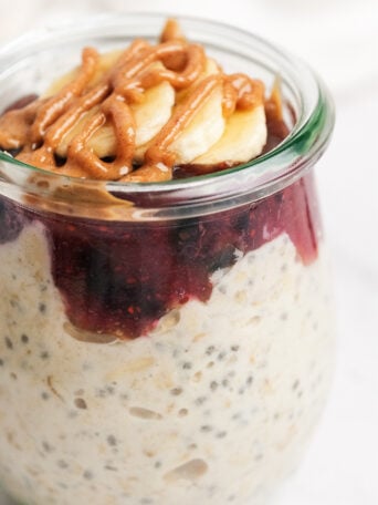 Berry Cheesecake Overnight Oats with drizzle peanut butter